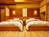 ～特別室「利久」～洋風ツインベッドルームには快適な眠りを追い求めたシモンズ社製のベッドを完備。